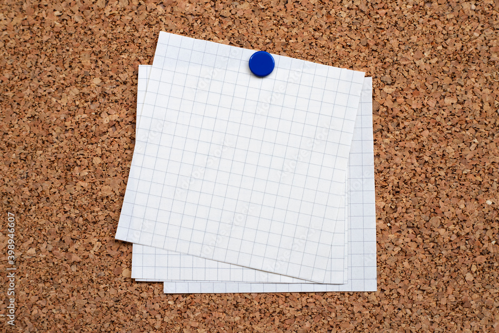blank note papers hanging with thumbtacks on the cork board blank note papers hanging with thumbtacks on the cork board