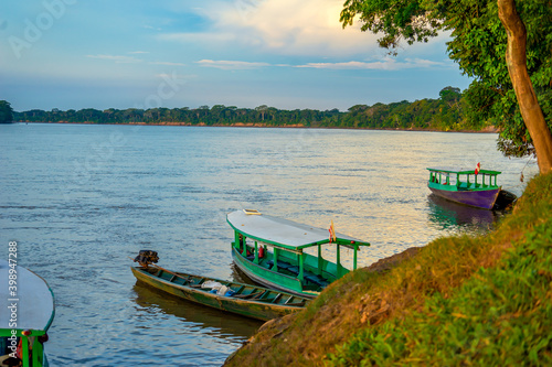 Peru, Amazonas, the large Rio Madre. Small ferry boats for crossing the river during sunset. photo
