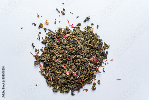 green tea with petals on white background