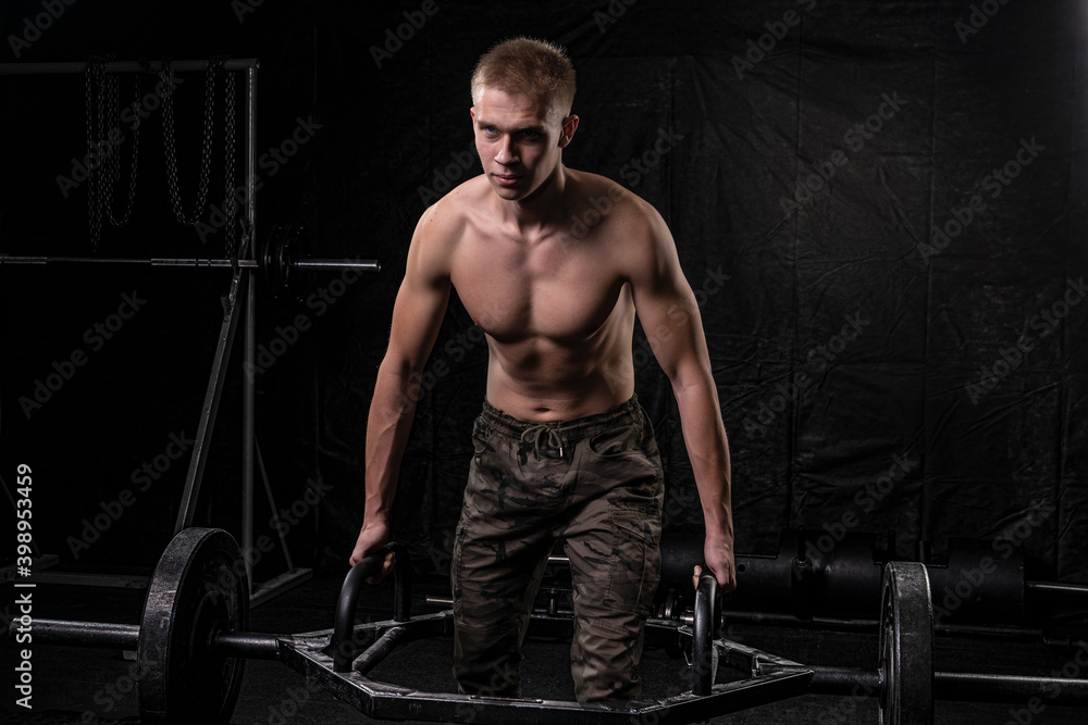 a young athlete performing a deadlift with a square bar a young athlete performing a deadlift with a square bar