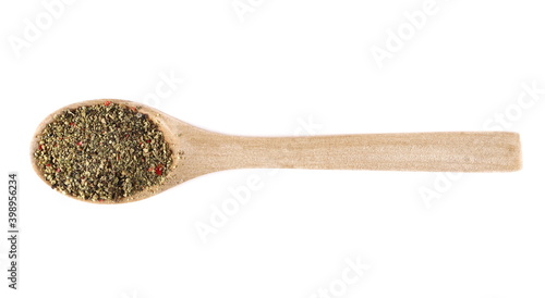 Colorful crushed pepper mix, flakes in wooden spoon isolated on white background, top view