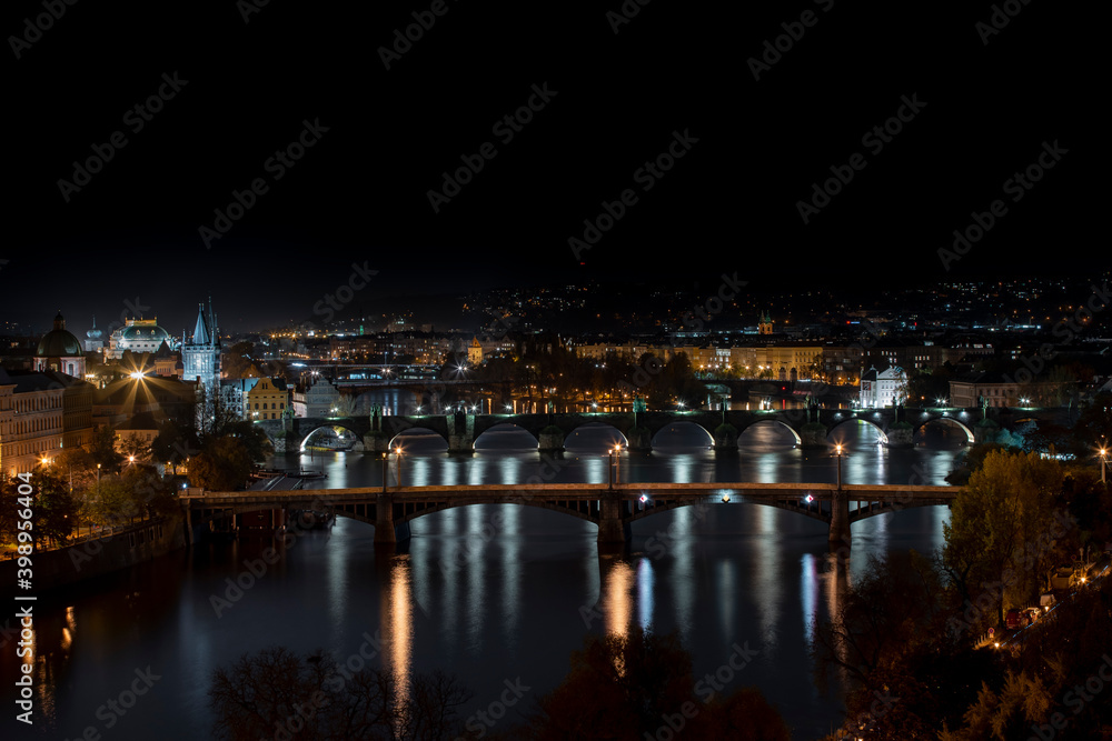 .view of illuminated bridges on the Vltava river in the center of Prague at night