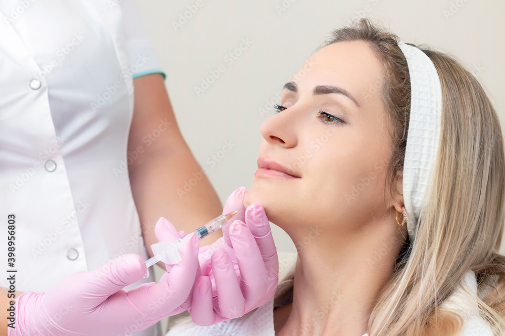 young woman receiving cosmetic injection. Woman in a beauty salon.
