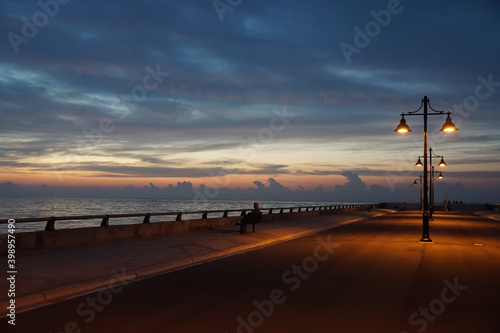 Key West pier and bench with street lamp just before sunrise © Zach