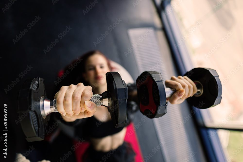 Athletic girl in sportswear performs exercises with barbell, dumbbells. Fitness, healthy lifestyle Athletic girl in sportswear performs exercises with barbell, dumbbells. Fitness, healthy lifestyle