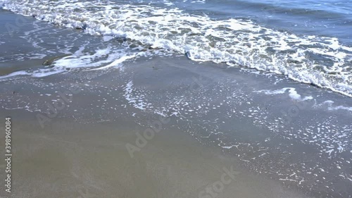 the waves of the mediterranean sea roll on the city beach