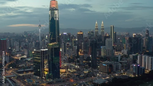 Establishing aerial cinematic drone b-roll shot of sunset at Kuala Lumpur city skyline.  photo