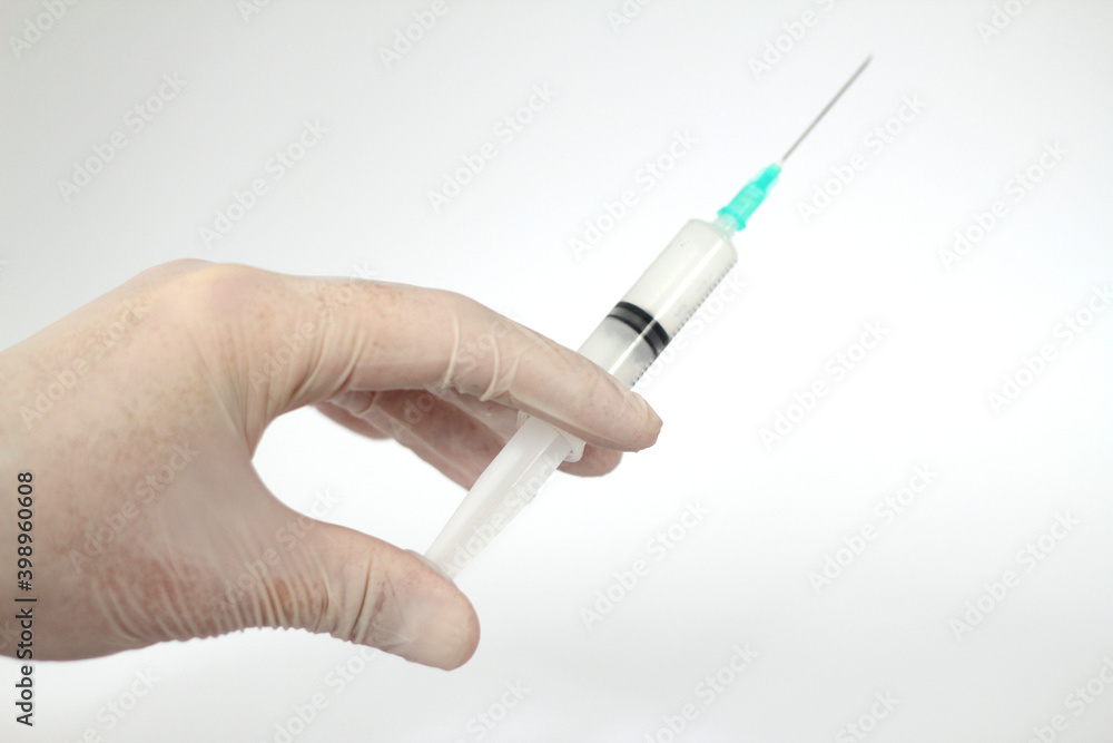 Medicine plastic vaccination equipment with needle in doctor or nurse hand isolated on white background. Health care concept. Hand holding syringe and vaccine. Injection syringe isolated. Medicine plastic vaccination equipment with needle in doctor or nurse hand isolated on white background. Health care concept. Hand holding syringe and vaccine. Injection syringe isolated.