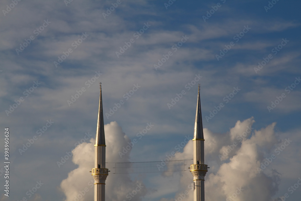 Two minarets on a background of blue morning sky.