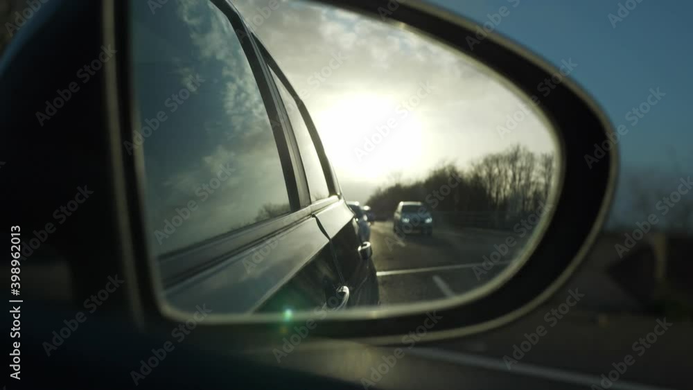 Close-up Car Side Mirror View Morning Evening Sunshine. Highway Expressway Country Road. Travelling by Car POV. France Europe. 2x Slow motion 60 fps 4K Close-up Car Side Mirror View Morning Evening Sunshine. Highway Expressway Country Road. Travelling by Car POV. France Europe. 2x Slow motion 60 fps 4K