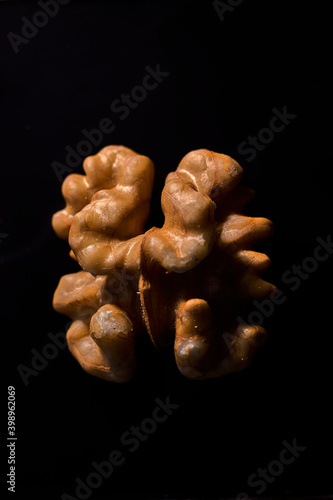 Close-up of half walnut, on a black background