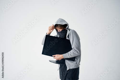 masked man with hood steals monitor technician hacker marking