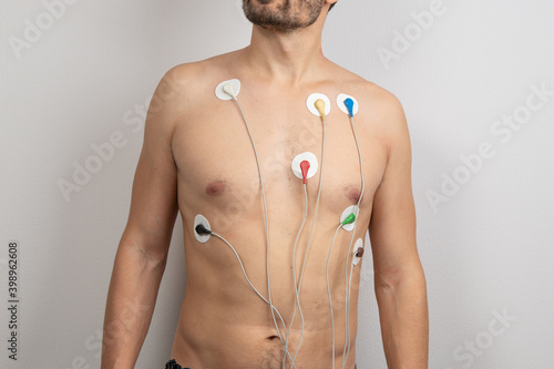 Young male body with ECG electrodes attached