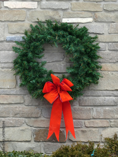 Wreath with red bow on the wall as Christmas decorations