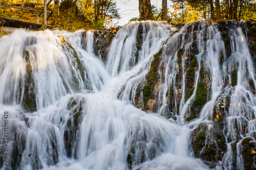 Fototapeta Naklejka Na Ścianę i Meble -  beautiful water ways at a large waterfall with colorful autumn forest