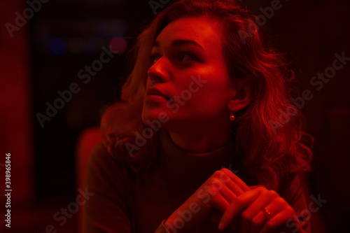 Portrait of young pretty woman model in red light
