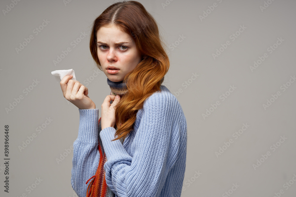 woman in blue sweater with napkin in hand health problems scarf infection flu woman in blue sweater with napkin in hand health problems scarf infection flu