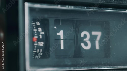 Vintage retro flip clock with the time advancing at a very fast pace showing how time passes fast. Old-style radio analog clock.