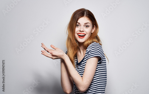 Pretty woman in striped t-shirt emotions hand gesture
