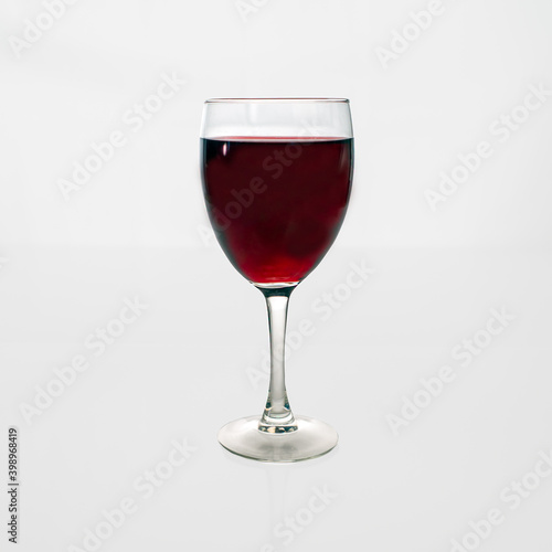 glass of red wine on a white background.
