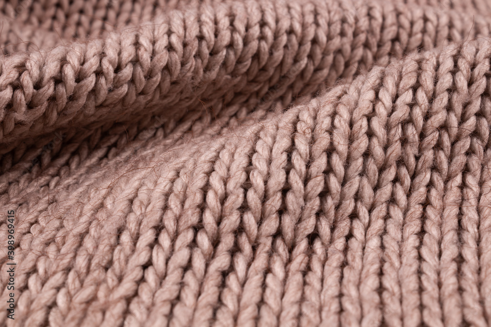 Light beige knitted wool fabric with large folds on the surface Light beige knitted wool fabric with large folds on the surface