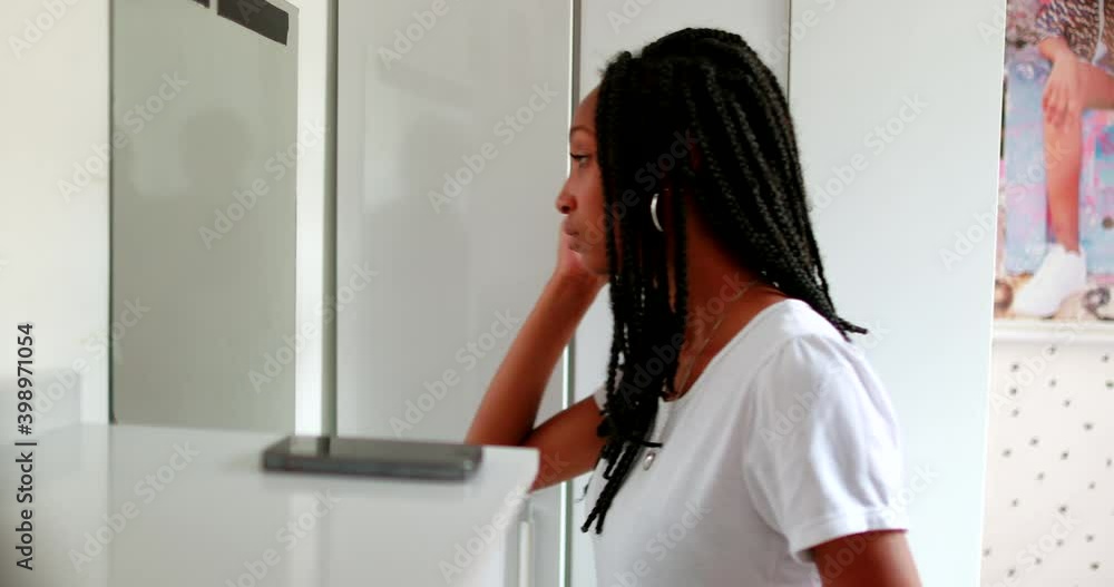 Black teen girl checking herself in front of mirror. African american teenager Black teen girl checking herself in front of mirror. African american teenager