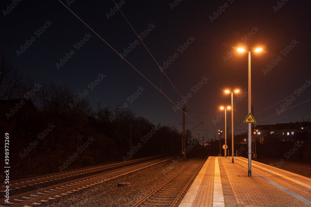 Night outdoor scenery of platform railway station in Düsseldorf, Germany.