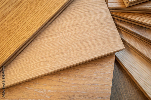 Top view, selective focus of light Engineered hardwood or laminate flooring samples.
