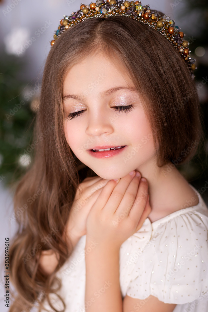 Cute girl in a Christmas decorated studio in pastel colors. Cute girl in a Christmas decorated studio in pastel colors.