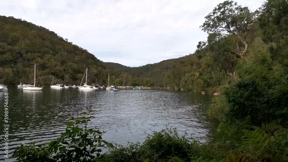 Beautiful time lapse video of a creek with boats and slow moving clouds on water, Apple Tree Creek, Bobbin Head, Ku-ring-gai Chase National park, Sydney, New South Wales, Australia
Beautiful time lapse video of a creek with boats and slow moving clouds on water, Apple Tree Creek, Bobbin Head, Ku-ring-gai Chase National park, Sydney, New South Wales, Australia