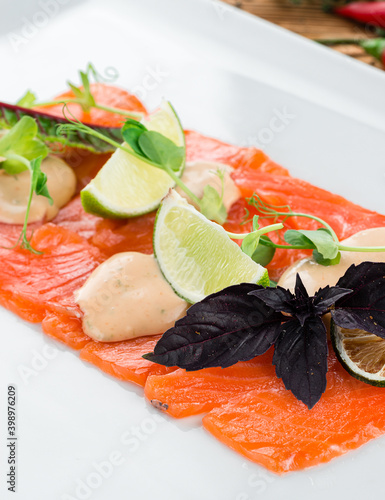 Salmon fillet, creative serving salmon sashimi with lime and Basil. Healthy concept, gluten free, lectine free photo