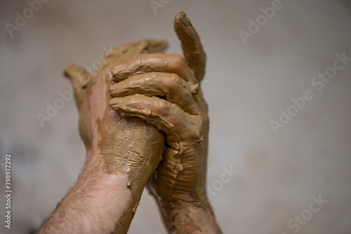 hands full of clay potter craft