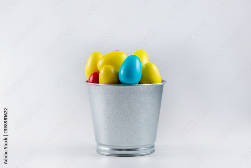 Colorful Plastic Easter Eggs in a metal bucket on white background Colorful Plastic Easter Eggs in a metal bucket on white background
