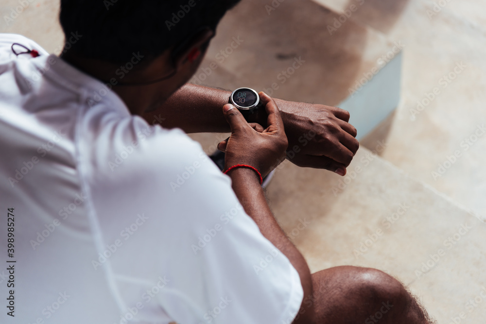 Εκτύπωση καμβά Close up Asian young athlete sport runner black man wear modern time smart watch