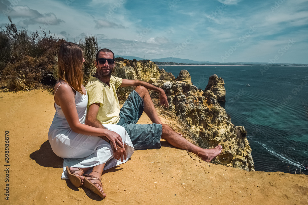 Young couple and cliffs in Lagos, Algarve, South Portugal