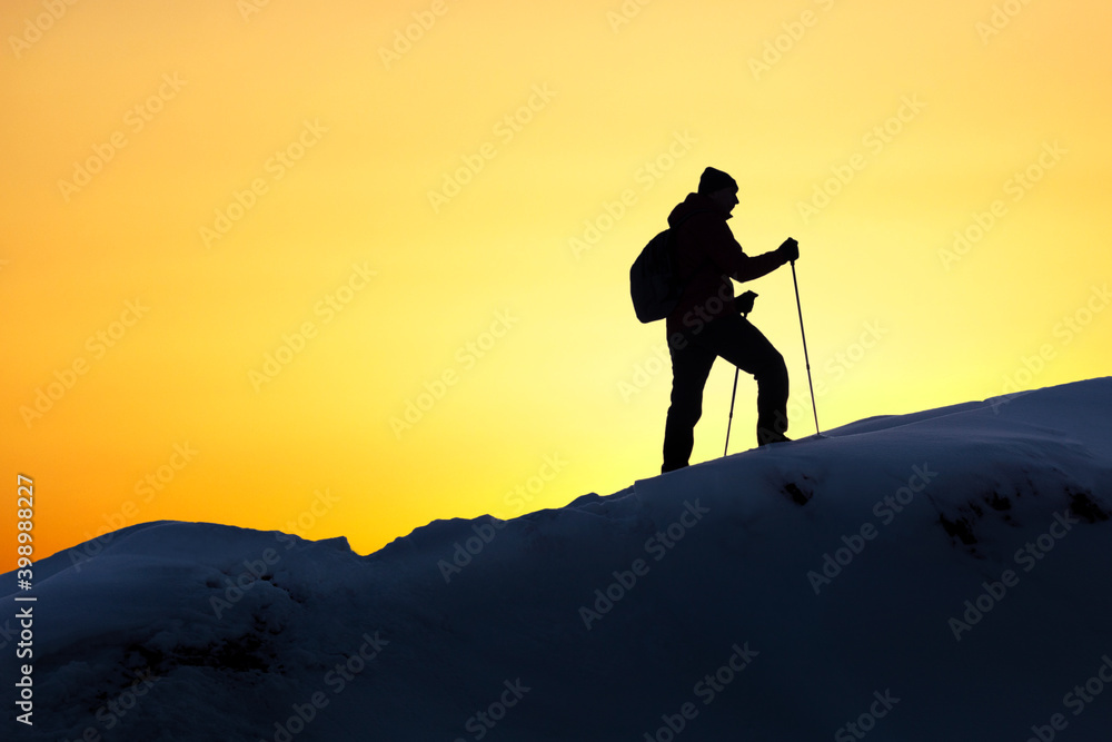 Man Hiking Silhouette In Mountains, Winter And Sunset.  Healthy Active Lifestyle.
