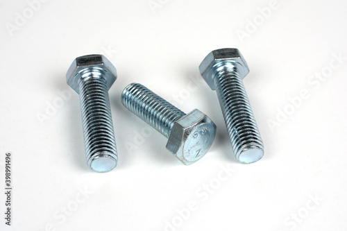 three bolts of metal on a white background