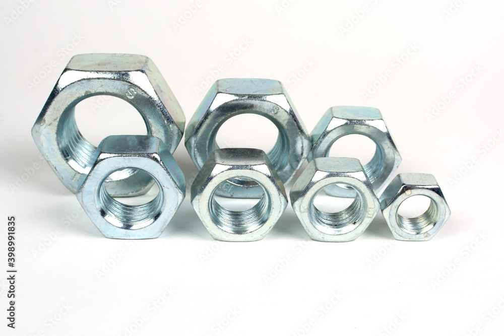 galvanized metal nuts of different sizes close-up galvanized metal nuts of different sizes close-up