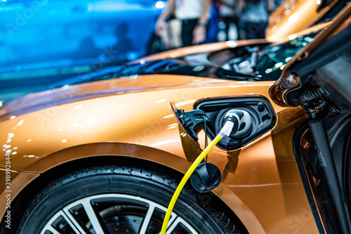 E-power car concept, car electric power charging, EV car concept, technology power of the car, close up EV charging. © Kenstocker