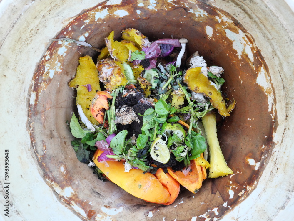 Peel and scraps of pineapples with papaya fruit and vegetable in a