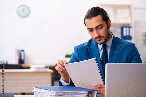 Young male sales analyst sitting in the office