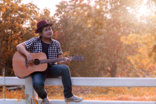 Men playing acoustic guitar happily 