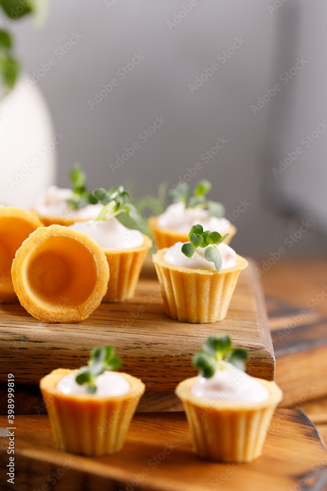 Canapes with light cream filling. Still life with microgreens. The concept of an appetizing snack. Canapes with light cream filling. Still life with microgreens. The concept of an appetizing snack.