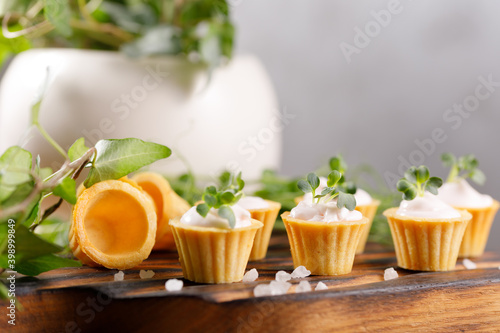 Canapes with light cream filling. Still life with microgreens. The concept of an appetizing snack.