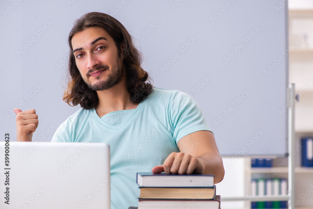 Young male student preparing for exams in tele-education concept Young male student preparing for exams in tele-education concept