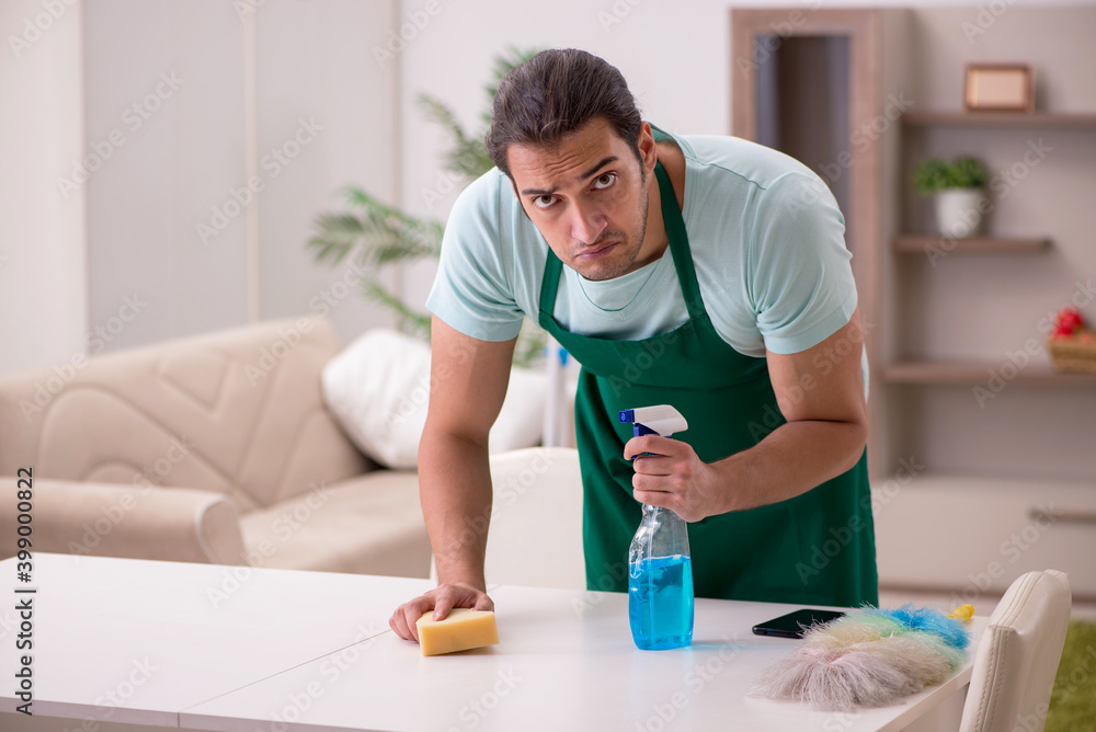 Young male contractor cleaning the house Young male contractor cleaning the house