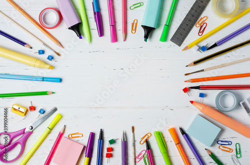 Children's accessories for study, creativity and office supplies on a white wooden background. Back to school concept. Copy space