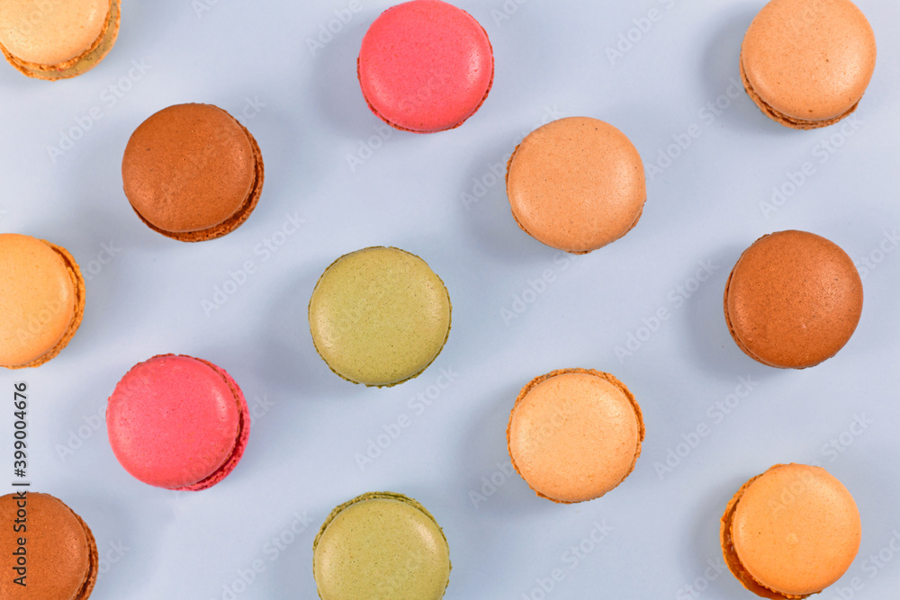 Top view of colorful French macaron sweets on blue background Top view of colorful French macaron sweets on blue background