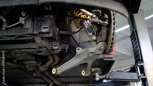 Disassembled car suspension, lever unscrewed