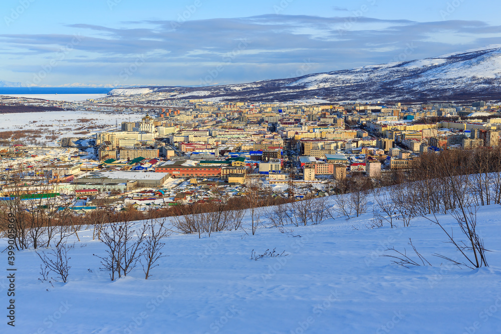 Winter cityscape. Top view of the northern city. The city of Magadan is located among the mountains on the coast of the Sea of ​​Okhotsk. The administrative center of the Magadan Region, Russia.